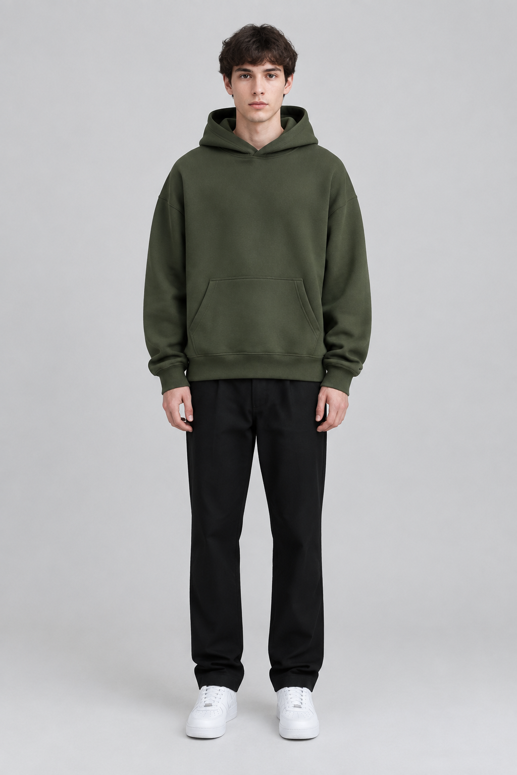 Model wearing the SAUVRIM Olive Arch hoodie, front view