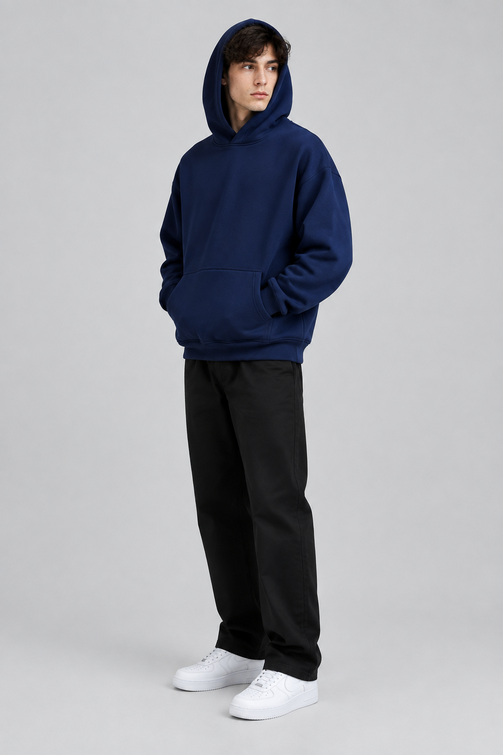 Model wearing the SAUVRIM Blue Browl hoodie with the hood up