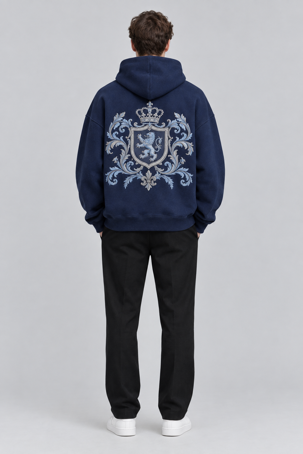 Model wearing the SAUVRIM Blue Browl hoodie, back view with the crest embroidery