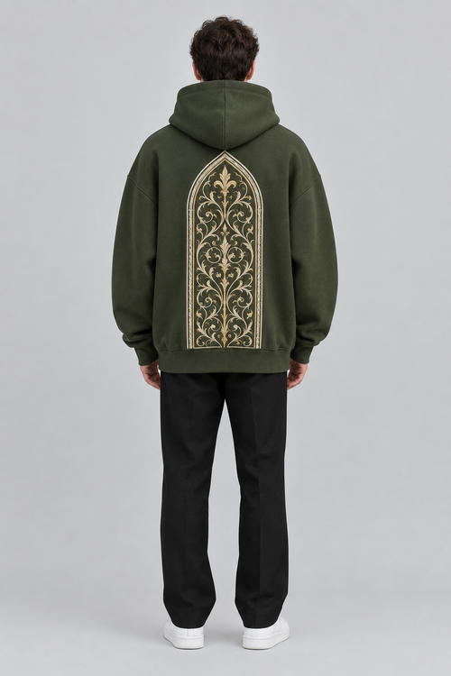 Model wearing the SAUVRIM Olive Arch hoodie, back view with the arch embroidery