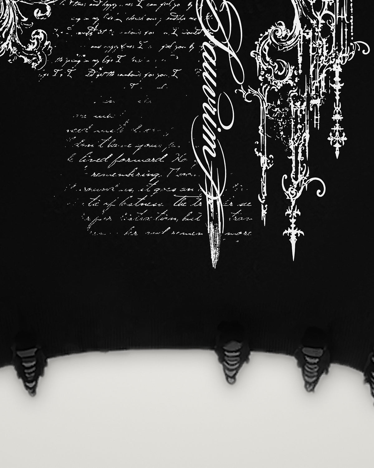 Ripped rib hem and the lower back print of the Sword & Script hoodie